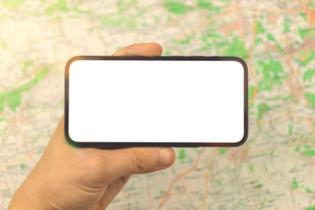 Man hold and use mobile phone mockup horizontally, map navigation concept, city map background, copy...