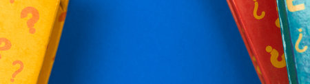 Learning and education banner with question signs on the books, blue desktop with copy space, school...