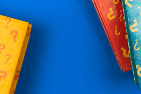 School education concept with creative books and question sign, blue table desktop with books, copy space and top viewの写真素材