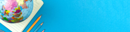 School geography lessons banner concept with the globe and pencils, creative flat lay blue desktop...