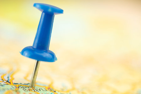 Close-up to the blue pushpin on the tourist map, selective focus