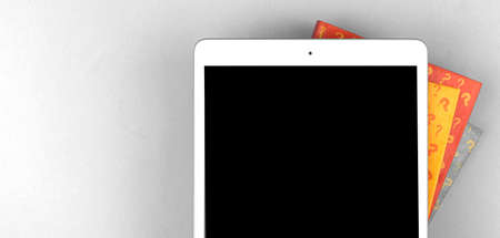 Question and answer banner and template with digital tablet mockup screen and book with question signs, white silver desktop background with copy space, top viewの写真素材