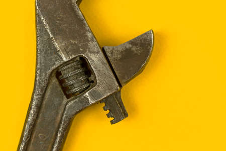 Close-up of adjustable wrench, old grunge repair tool, yellow background photoの写真素材