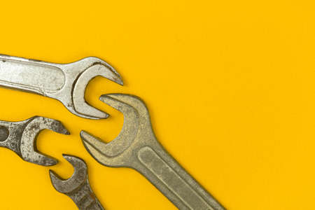 Handyman creative flat lay background, yellow office table with wrenches, copy spaceの写真素材