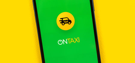 Kharkov, Ukraine - July 2, 2021: OnTaxi app logo and icon close-up, taxi application, yellow...