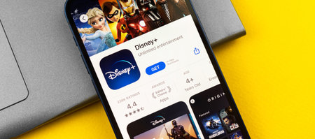 Kharkov, Ukraine - July 2, 2021: Disney Plus app on the screen of Apple smartphone, laptop...