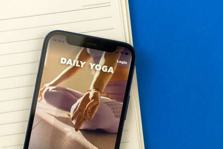 Kharkov, Ukraine - July 2, 2021: Daily Yoga app title screen close-up photoのeditorial素材