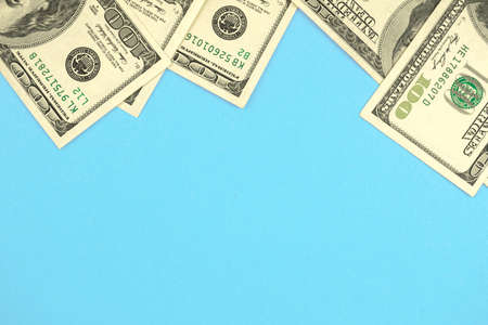 Money cash dollar frame composition, office desktop blue color background with copy space, top viewの写真素材