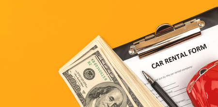 Car rental agreement cotract. Business office desktop with money, pen and car toy. Top viewの写真素材
