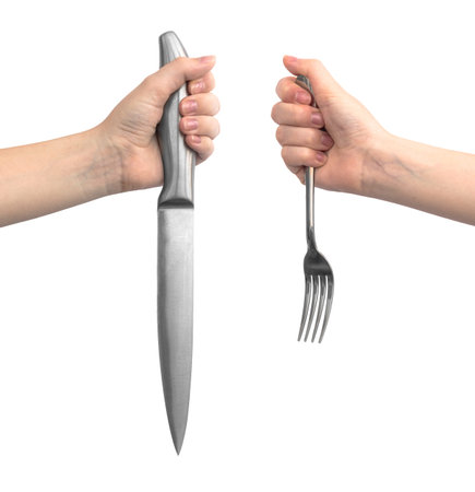 Kitchen utensil in hand. Woman hold steel knife and fork, isolated on a white background