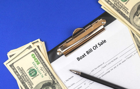 Buy new boat with official documents. Boat bill of sale agreement on blue office table with money...