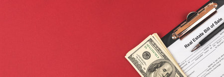 Real estate bill of sale contract. Banner desktop with clipboard, money and pen. Copy space and top viewの写真素材