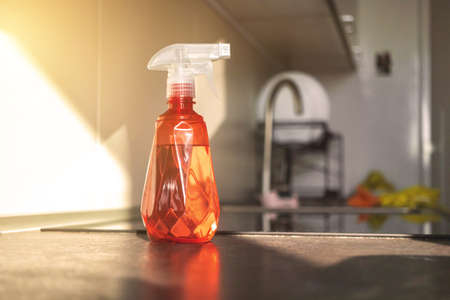 Spray bottle with water on kitchen table top, concept photo of kitchen cleaningの写真素材