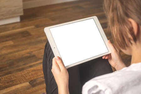 Tablet pc mockup. Woman with digital tablet in apartment, freelancer concept backgroundの写真素材