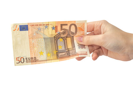 Fifty euro bill in hand isolated on white background, woman hand with banknote, europe money