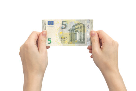 5 euro banknote in hands. Isolated on a white background. Woman holding europe union money bill...