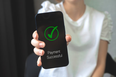 Woman hand with mobile phone and transaction application, payment successful screen, concept of e-commerce and online banking, payment transferの写真素材