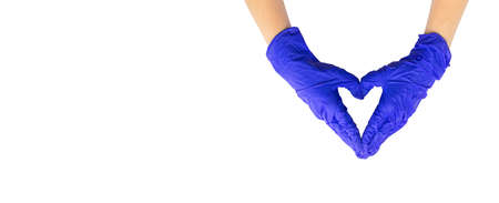Hand in medical rubber glove heart shape gesture, isolated on a white background photoの写真素材