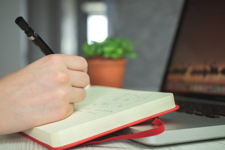 Artist drawing in sketch notebook by using pencil, creative pencil art, artistic creative workspace...