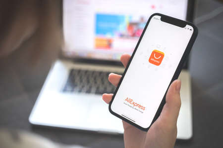 Kharkov, Ukraine - August 12, 2021: Aliexpress app. Woman using smartphone with aliexpress application. Brandのeditorial素材