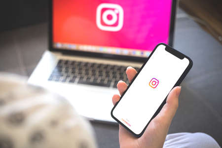 Kharkov, Ukraine - August 12, 2021: Instagram app. Woman using smartphone with instagram application. Brandのeditorial素材