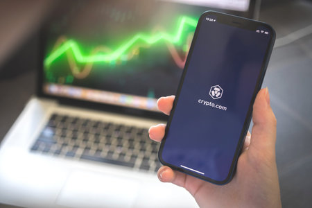 Kharkov, Ukraine - August 12, 2021: Crypto.com app. Woman using smartphone with crypto.com...