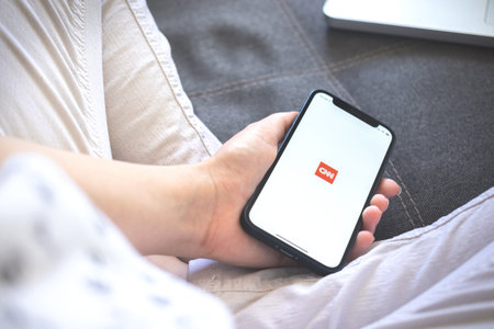 Kharkov, Ukraine - August 12, 2021: Cnn app. Woman using smartphone with cnn application. Brand