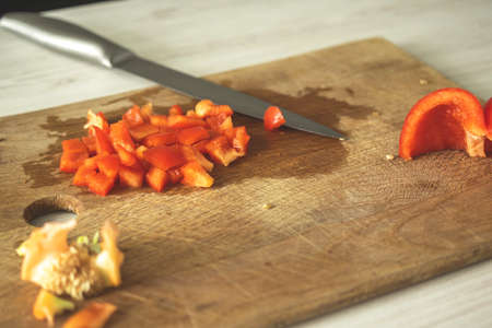 Sliced red sweet pepper on wooden board. Vegetable ingredient, cooking healthy food conceptの写真素材