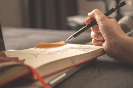 Autumn holidays with book or diary at home, indoors. Cozy and warm holidays backgroundの写真素材