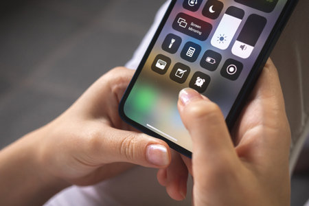 Kharkov, Ukraine - August 25, 2021: Apple iPhone 12 setting page closeup. Mobile phone in woman...