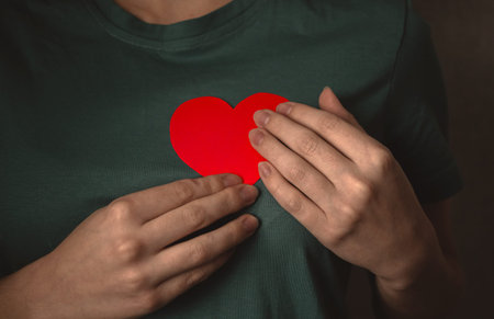Hands with red heart. Young teenager giving her love concept background photo