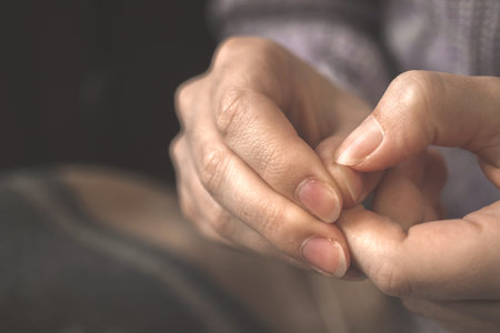 Girl bitting her nails closeup. Anxious, stressed, frustrated, neurotic and confused woman in warm...