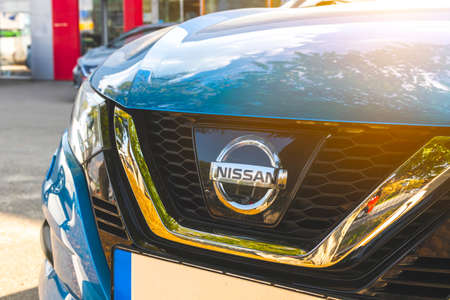 Kharkov, Ukraine - September 13, 2021: Nissan brand logo on a blue car background, emblem, symbol close-upのeditorial素材