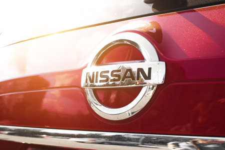 Kharkov, Ukraine - September 13, 2021: Nissan japan brand logo on a red car background, emblem, symbol close-upのeditorial素材