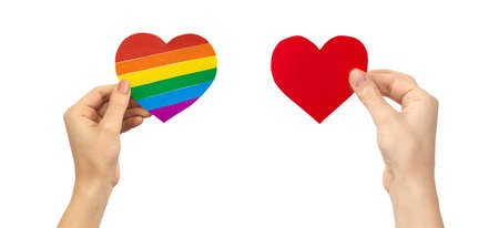 Tolerance and discrimination concept. Hands with LGBT rainbow heart and red heart. Gay and lesbian rights photoの写真素材