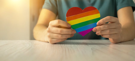 Hands with rainbow color flag in heart shape, symbol of LGBT pride month celebrate, community of gay, lesbian, bisexual and transgender, human rights conceptの写真素材