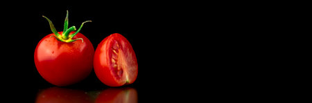 Banner design for cooking. Washed cherry tomatoes on a black background. Close-up view. Healthy eating conceptの写真素材