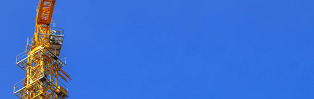 Tower building equipment construction crane cabin closeup on blue sky background, banner photo with copy spaceの写真素材