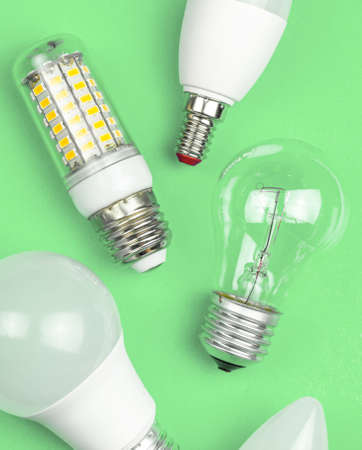 Different kinds of light bulbs together, eco green background. Energy saving concept. Flat lay, top viewの写真素材