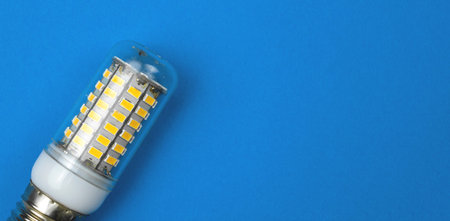 LED light bulb, blue background. Flat lay, top view, copy space photoの写真素材