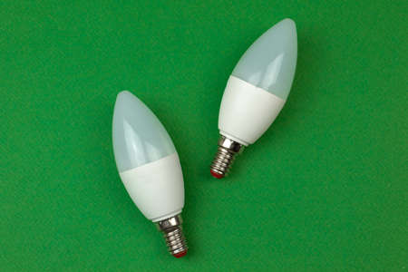 Energy saving and eco friendly LED light bulbs. Green background, flat lay, top view and copy spaceの写真素材