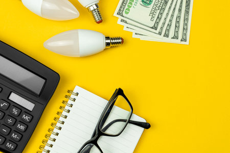 Calculating house energy efficiency rate. Calculator, LED light bulbs and money. Energy saving...