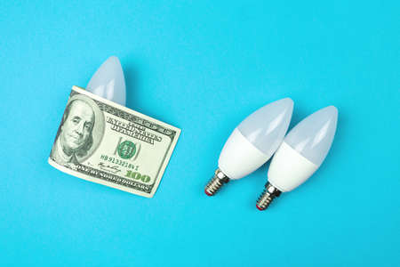 Energy efficiency concept. LED light bulb and dollar money bill. Saving energy banner photoの写真素材