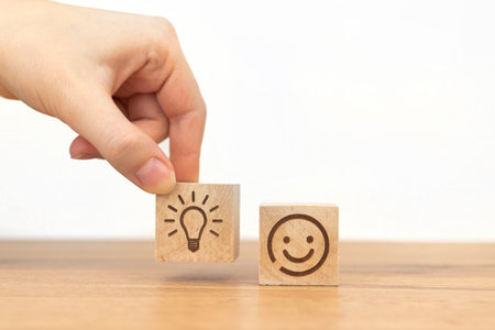 Creative idea concept. Business success and new strategy. Wooden cube with light bulb and smiley...