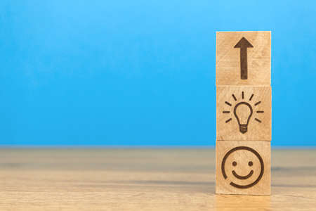 Business strategy and action plan concept. Success and creative ideas background. Wooden block with light bulb and arrow up icons, copy space photoの写真素材