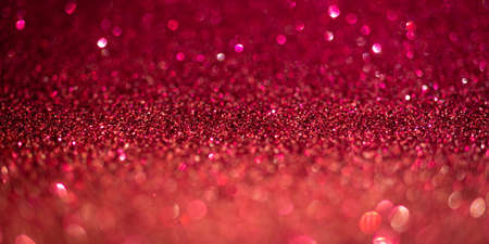 Magenta glitter lights. Shiny sparkles, bokeh effects, glowing surface. Selective focus, christmas abstract banner, background photoの写真素材