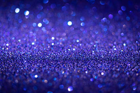 Abstract blue shiny glitter texture. Selective focus. Glowing surface, sparkle lights and bokeh effects. Christmas and festive background photoの写真素材