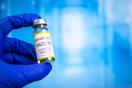 Kharkov, Ukraine - November 3, 2021: Doctor hand with AstraZeneca vaccine. Laboratory research. COVID-19, hospital background photoのeditorial素材