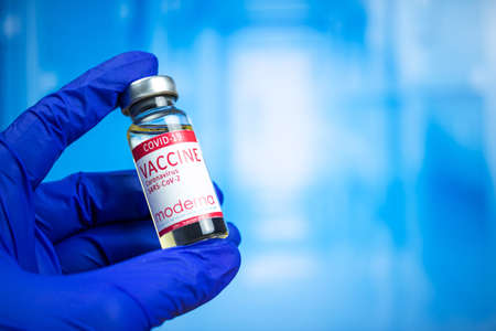 Kharkov, Ukraine - November 3, 2021: Doctor hand with Moderna vaccine. Laboratory research. COVID-19, hospital background photoのeditorial素材