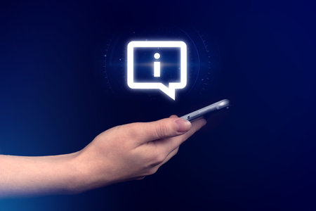 Business connection, contact us, customer service concept. Info icon and mobile phone in hand, technology and networking background. Modern communicationの写真素材